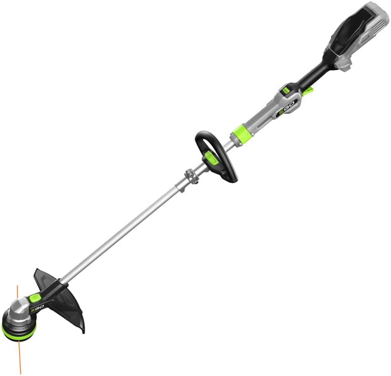 String trimmer cutting grass along a fence
