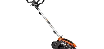 The image shows a person using a powerful electric lawn edger to create a clean border.