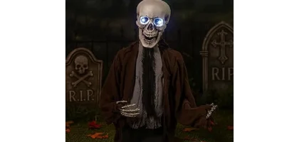 The image shows a spooky animated skeleton prop in a yard, perfect for the Best 9 Animated Halloween Props.