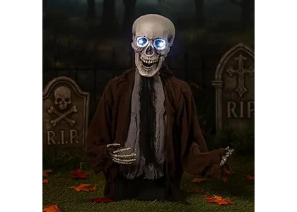The image shows a spooky animated skeleton prop in a yard, perfect for the Best 9 Animated Halloween Props.