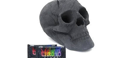 The image shows a close-up of realistic ceramic skull logs arranged in an outdoor fire pit.