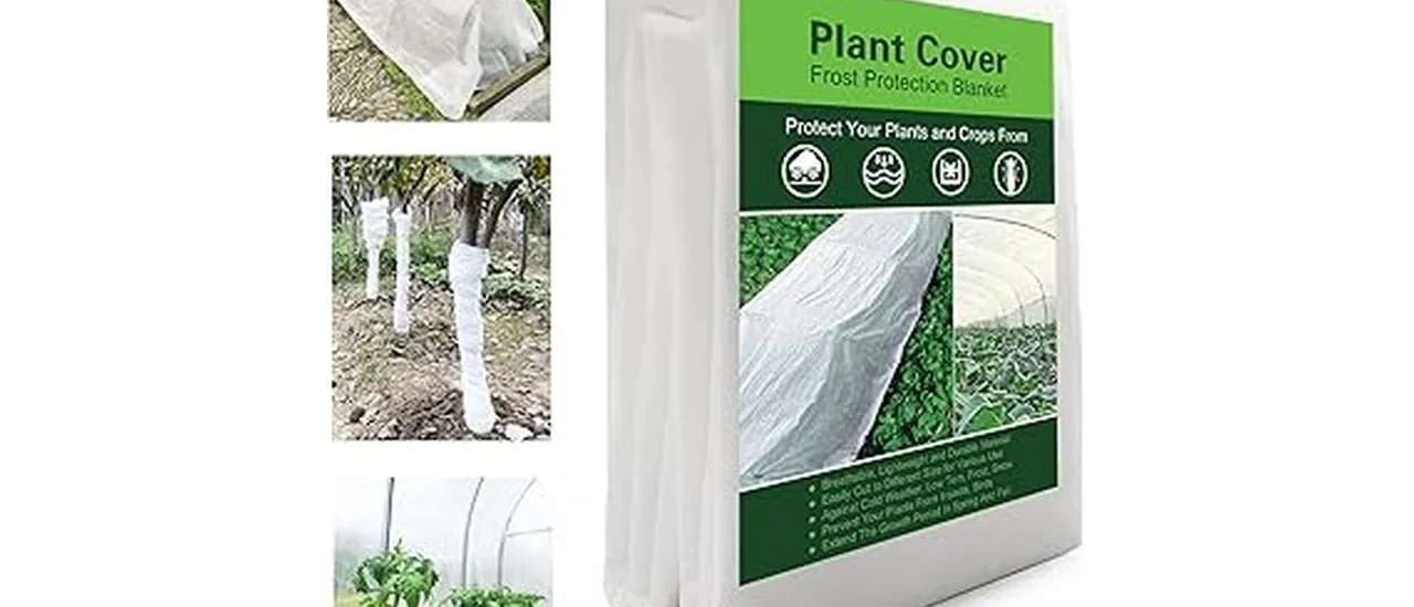The image shows a garden bed covered with frost blankets protecting winter vegetables from cold.