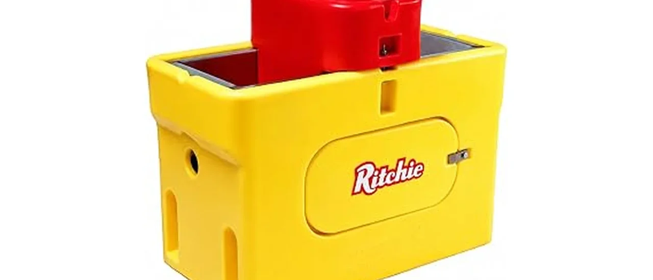 The image shows a durable, heated livestock waterer providing fresh water to farm animals in a snowy pasture.