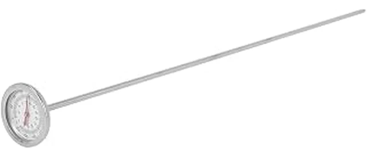 The image shows a close-up of a soil temperature probe inserted into dark earth.
