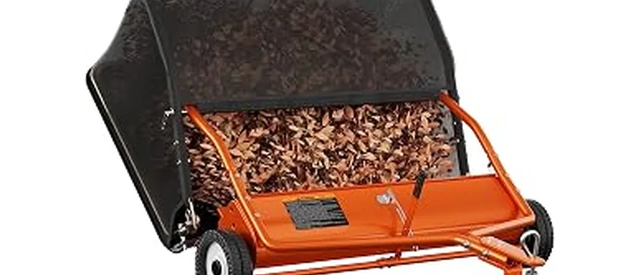 The image shows a tow-behind lawn sweeper collecting grass clippings for a large yard.