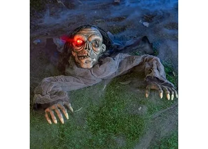 The image shows a festive outdoor Halloween display with pumpkins and spooky figures, part of a clearance sale.